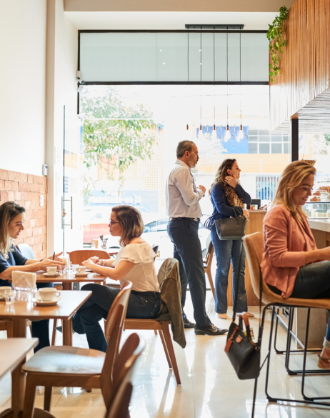 People sitting and standing in a cafe
